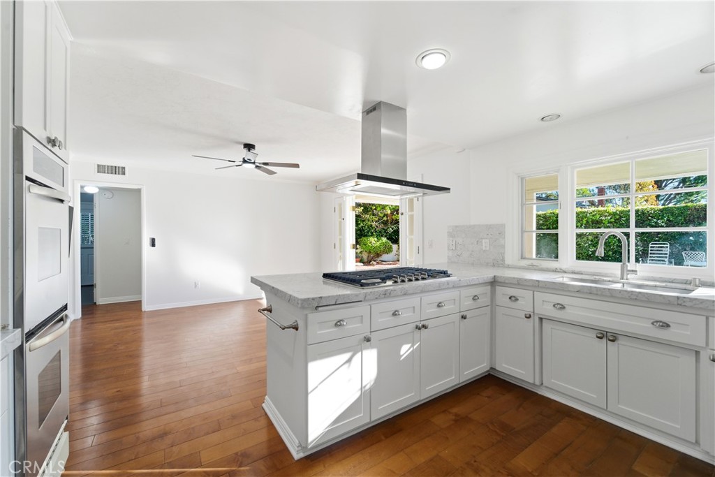 11344 Baird Avenue Porter Ranch, CA 91326 - Photo 13 of 45 a kitchen with granite countertop a stove a sink and a refrigerator