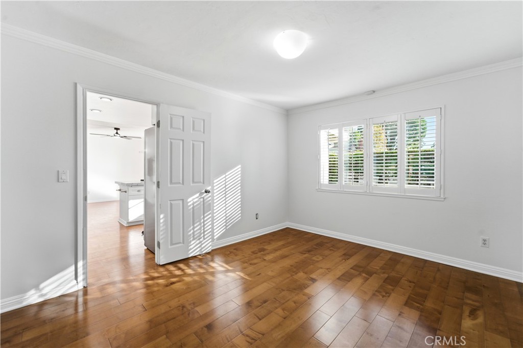 11344 Baird Avenue Porter Ranch, CA 91326 - Photo 16 of 45 a view of an empty room with wooden floor and a window