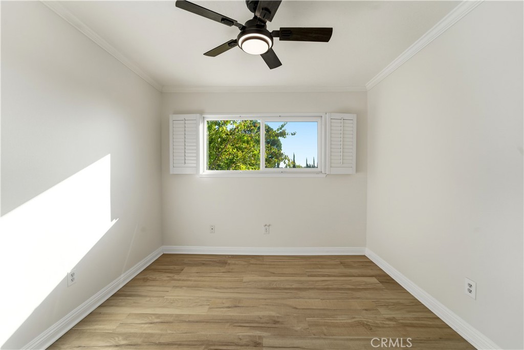 11344 Baird Avenue Porter Ranch, CA 91326 - Photo 24 of 45 an empty room with wooden floor ceiling fan and windows
