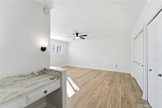 a view of a bathroom with a sink and a wooden floor