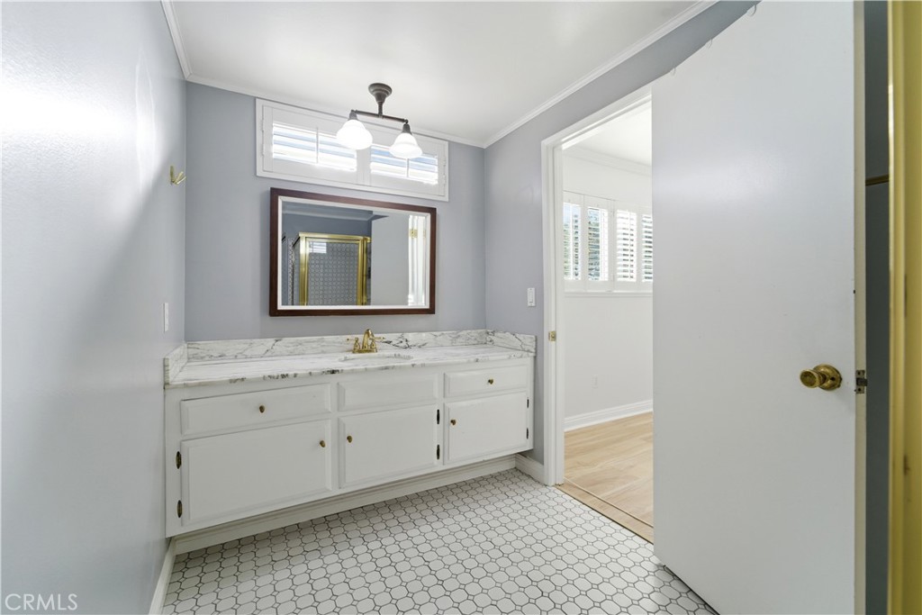 11344 Baird Avenue Porter Ranch, CA 91326 - Photo 33 of 45 a bathroom with a sink a mirror and a window