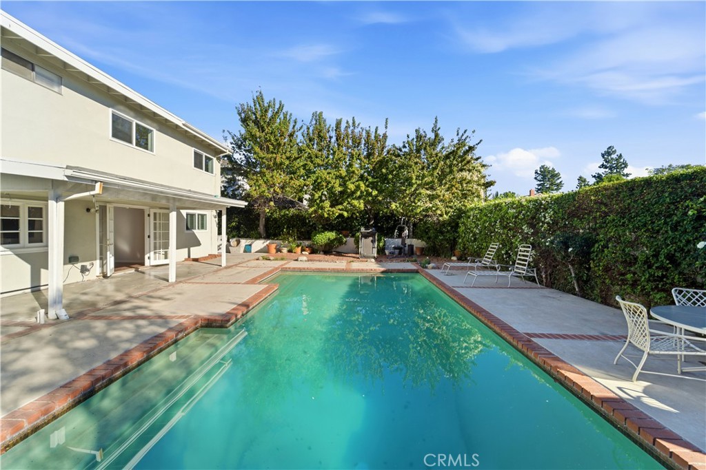 11344 Baird Avenue Porter Ranch, CA 91326 - Photo 36 of 45 a swimming pool with outdoor seating and garden