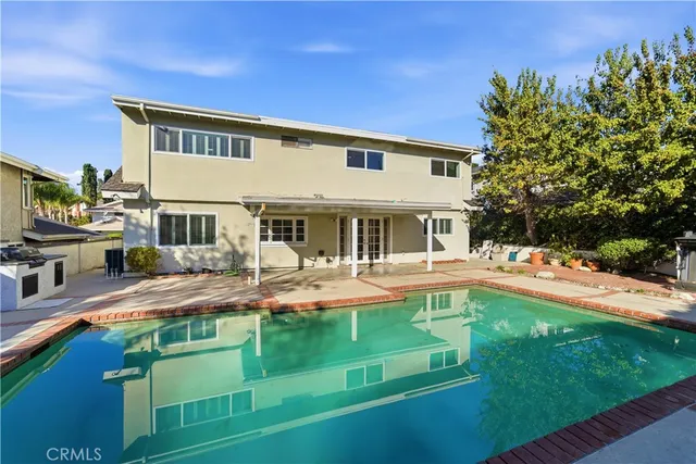 a front view of house with yard and swimming pool