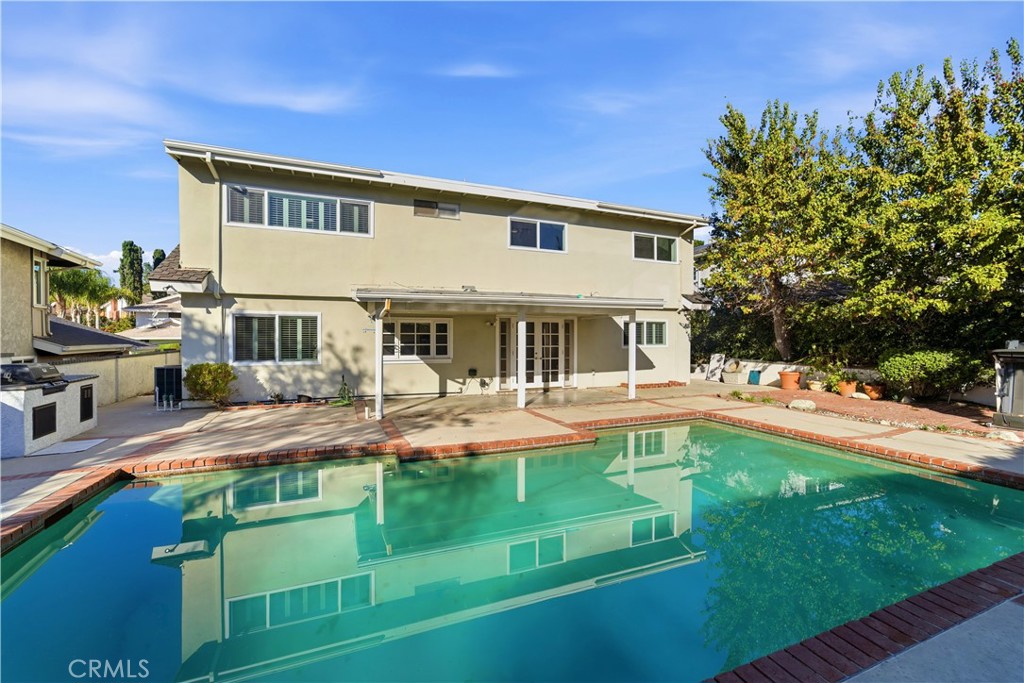 11344 Baird Avenue Porter Ranch, CA 91326 - Photo 39 of 45 a front view of house with yard and swimming pool