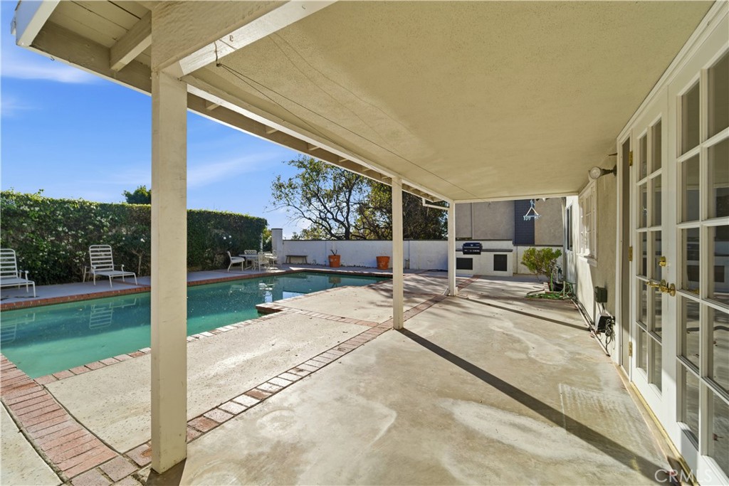 11344 Baird Avenue Porter Ranch, CA 91326 - Photo 40 of 45 a view of a patio with a table and chairs and couches with wooden fence
