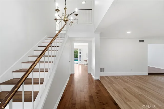a view of entryway and hall with wooden floor