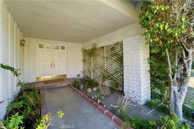 a view of a house with a backyard and a garden