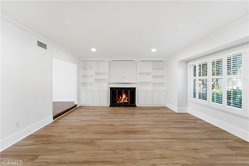 11344 Baird Avenue Porter Ranch, CA 91326 - Photo 6 of 45 a view of an empty room with wooden floor and a window