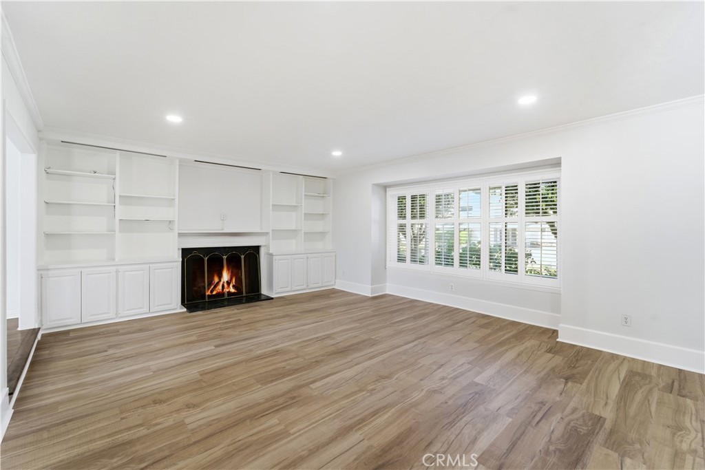 11344 Baird Avenue Porter Ranch, CA 91326 - Photo 7 of 45 a view of an empty room with wooden floor fireplace and a window