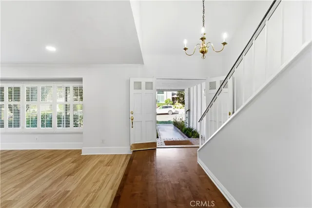 a view of an entryway with wooden floor and a chandelier