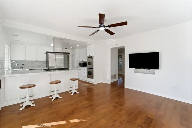 a living room with furniture and flat screen tv