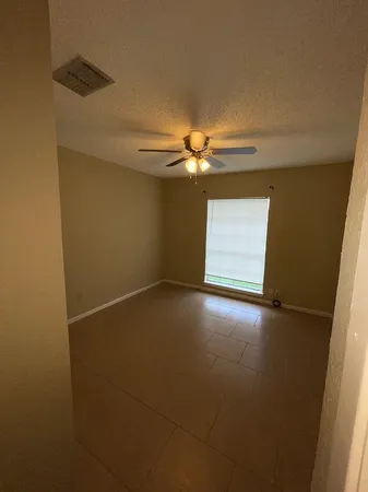 an empty room with a empty space and a window