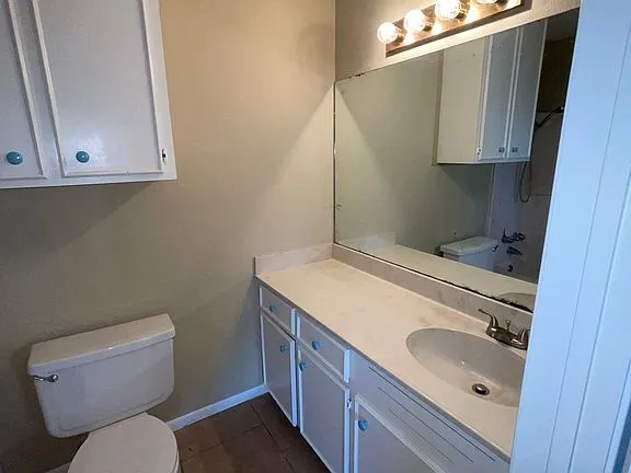 a bathroom with a sink toilet and vanity