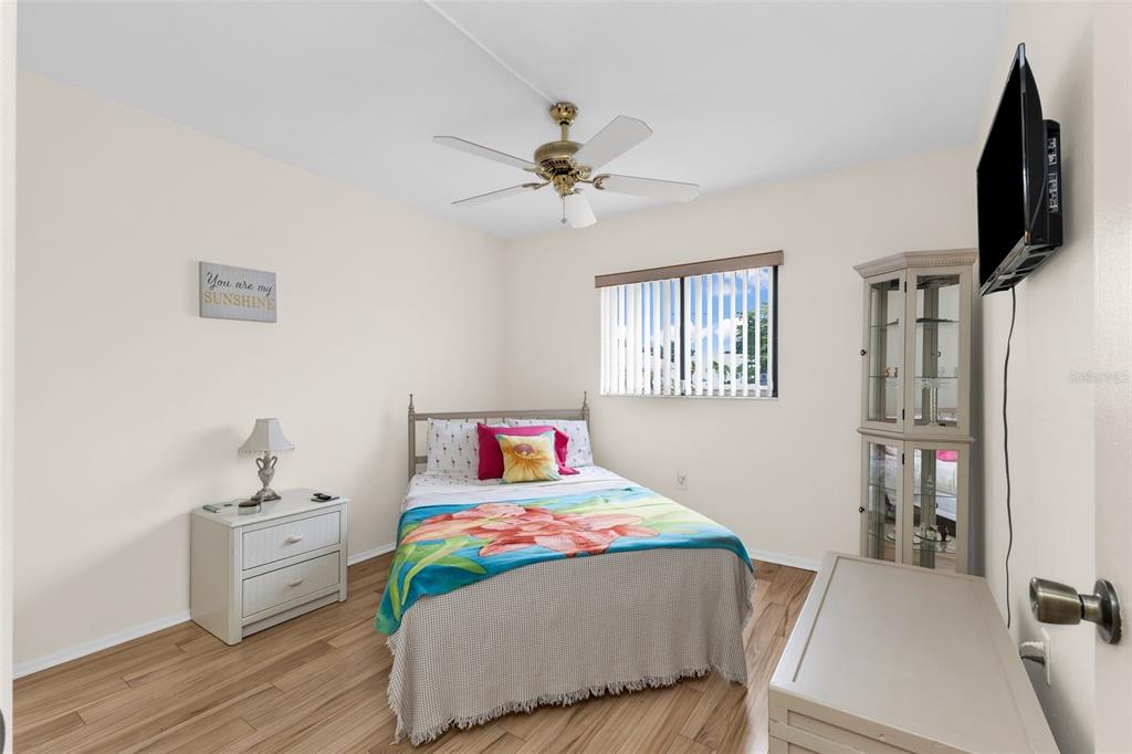 25225 Rampart Boulevard, Unit 1604 Punta Gorda, FL 33983 - Photo 21 of 41 a bedroom with furniture and a wooden floor