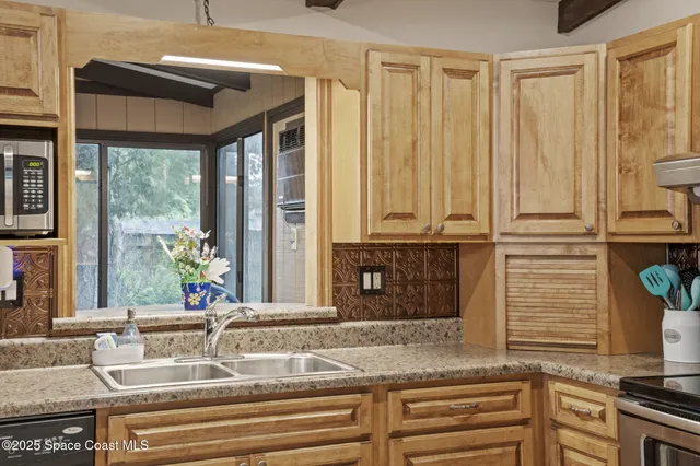 a bathroom with a granite countertop sink and a large mirror