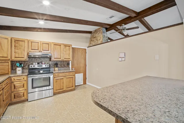 a kitchen with granite countertop a sink stainless steel appliances and cabinets