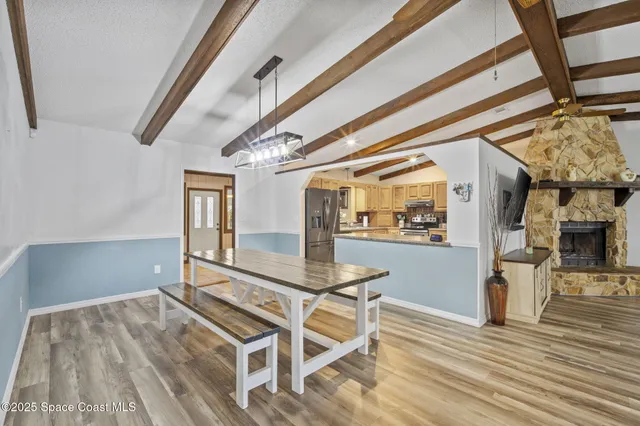 a view of dining room with furniture and wooden floor
