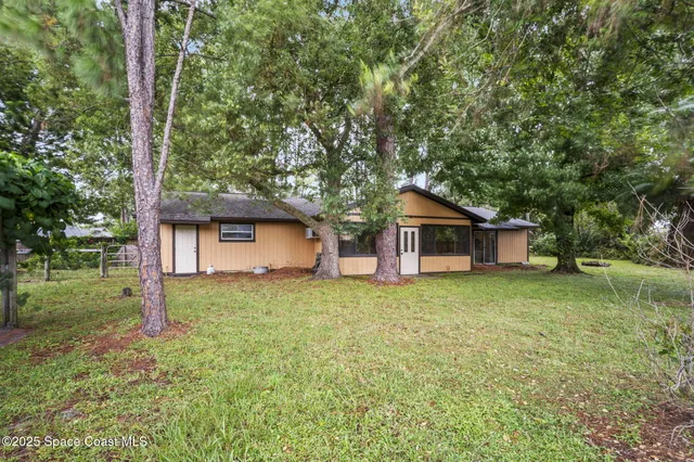 a house with trees in the background