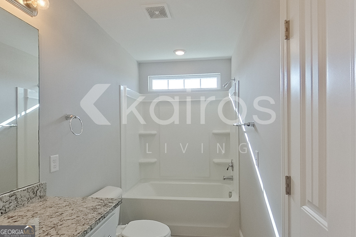 228 Western Red Cedar Drive Springfield, GA 31329 - Photo 21 of 27 a bathroom with a granite countertop sink a toilet and shower