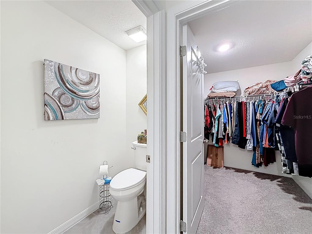 13677 Southwest 69th Terrace Ocala, FL 34473 - Photo 14 of 28 a view of walk in closet with clothes and shoes
