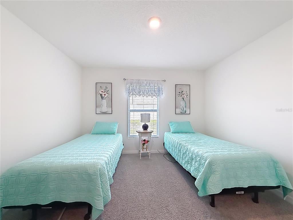 13677 Southwest 69th Terrace Ocala, FL 34473 - Photo 18 of 28 a bedroom with a bed and a window