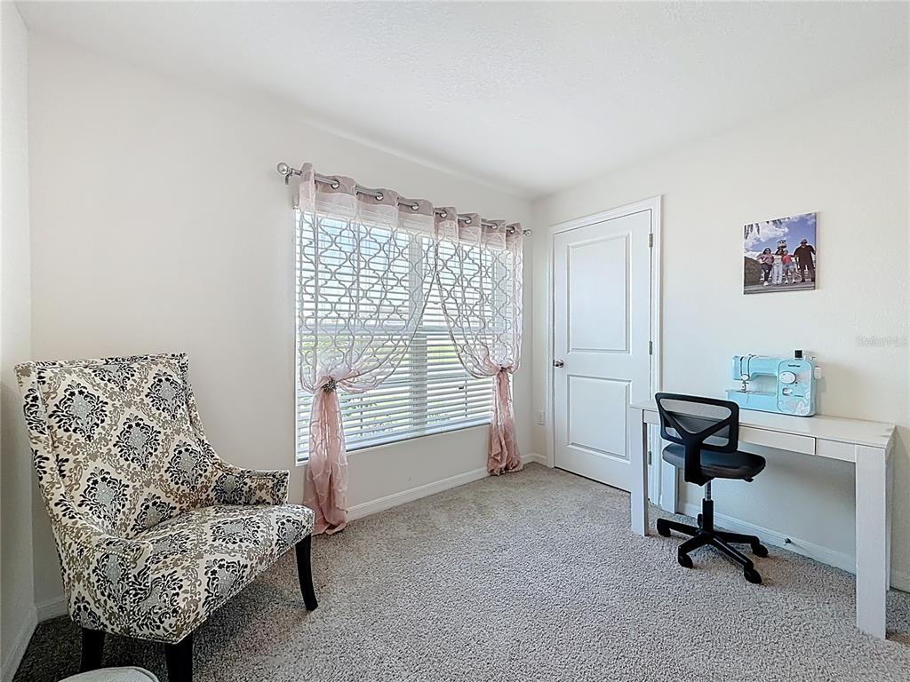 13677 Southwest 69th Terrace Ocala, FL 34473 - Photo 20 of 28 a view of a livingroom with workspace and a couch