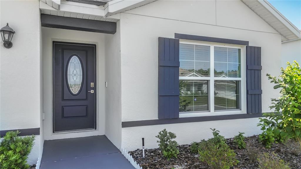 13677 Southwest 69th Terrace Ocala, FL 34473 - Photo 2 of 28 a front view of a house with garden