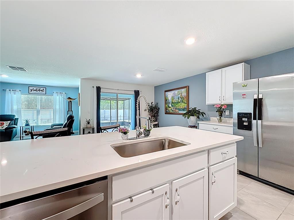 13677 Southwest 69th Terrace Ocala, FL 34473 - Photo 5 of 28 a kitchen with stainless steel appliances a sink a stove and refrigerator