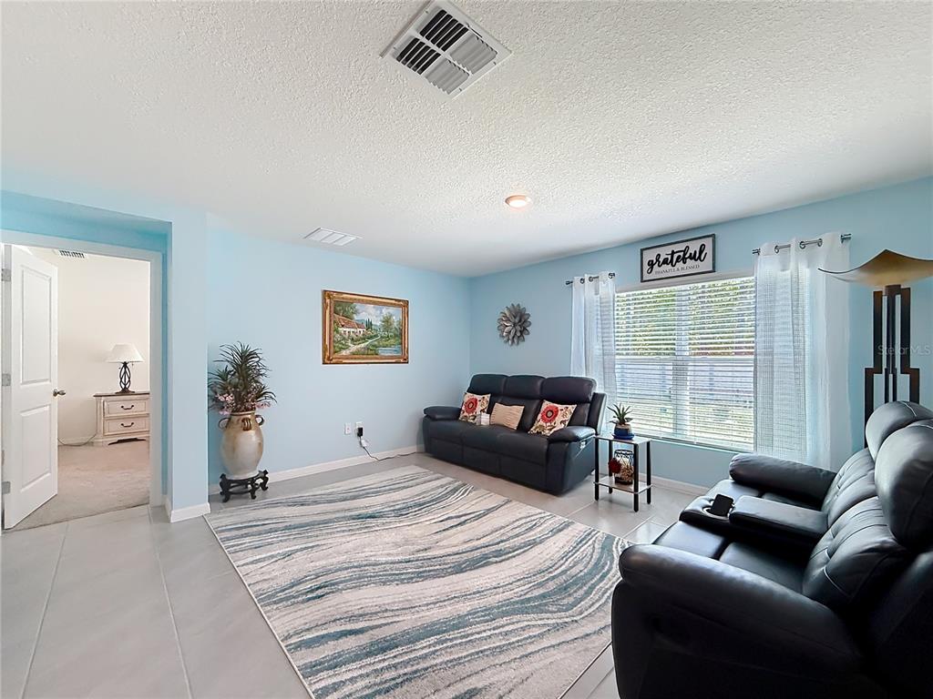 13677 Southwest 69th Terrace Ocala, FL 34473 - Photo 8 of 28 a bedroom with furniture and a window