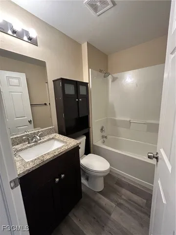 a bathroom with a sink toilet a mirror and shower