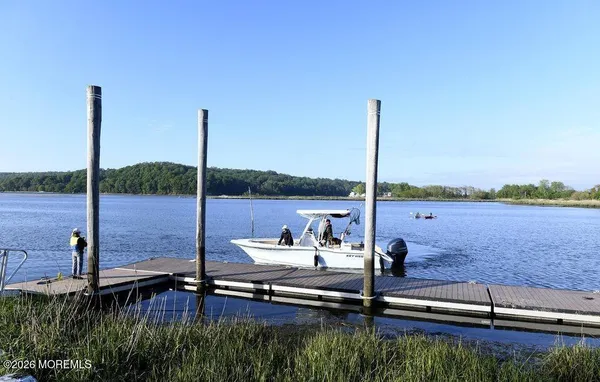 a view of a lake with a floor to ceiling window and wooden floor