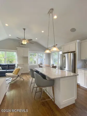 a kitchen with kitchen island a dining table and chairs