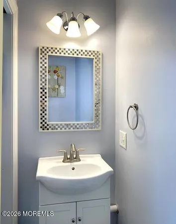 a bathroom with a sink mirror and vanity