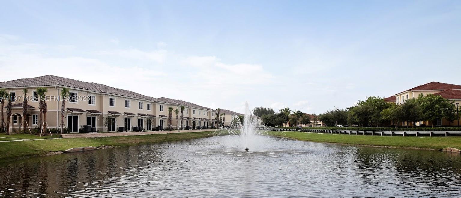 a view of swimming pool with a yard and wooden fence