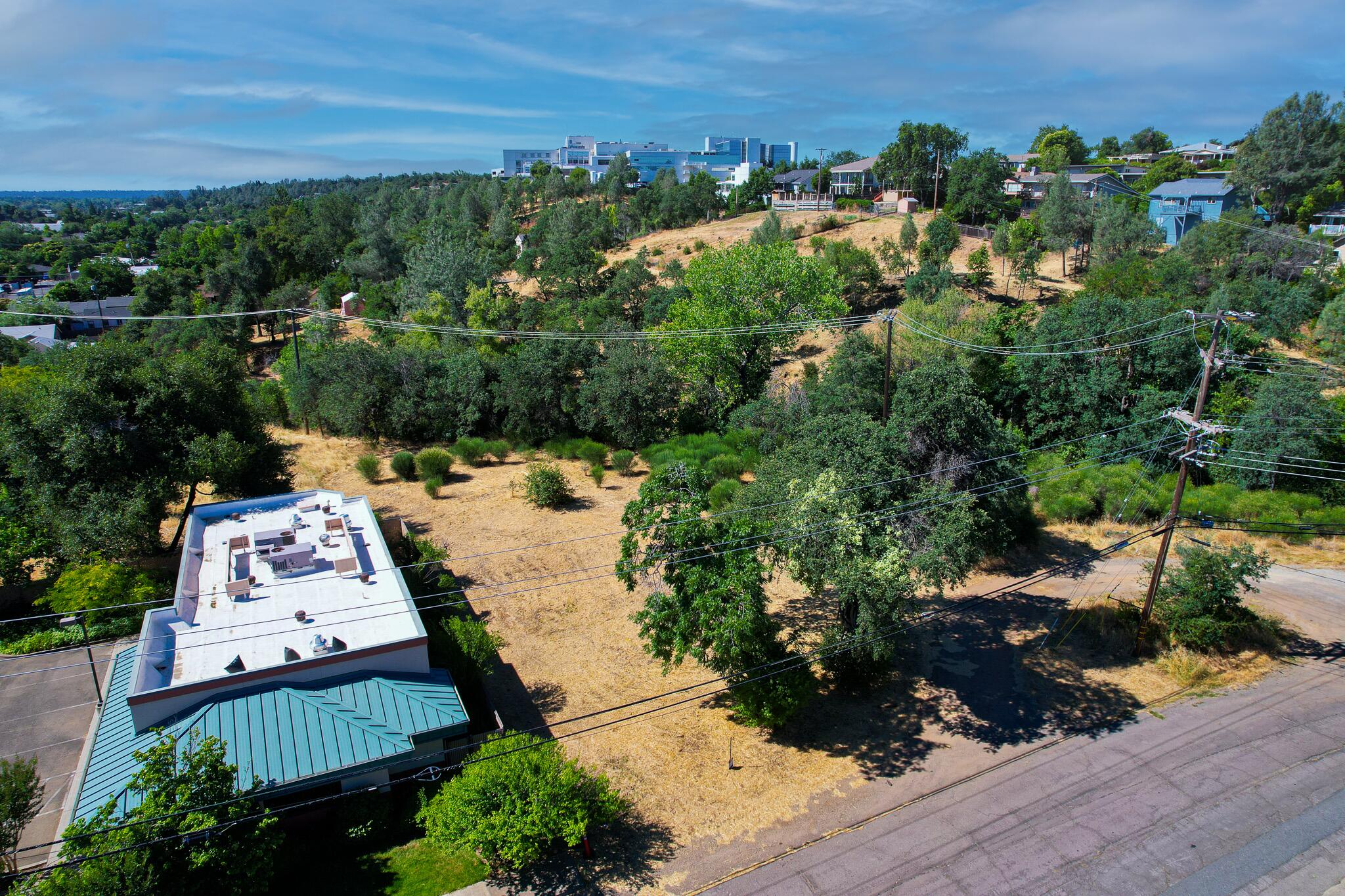 1875 Sonoma Street Redding, CA 96001 - Photo 5 of 9 an aerial view of a house with a yard lake view and mountain view in back