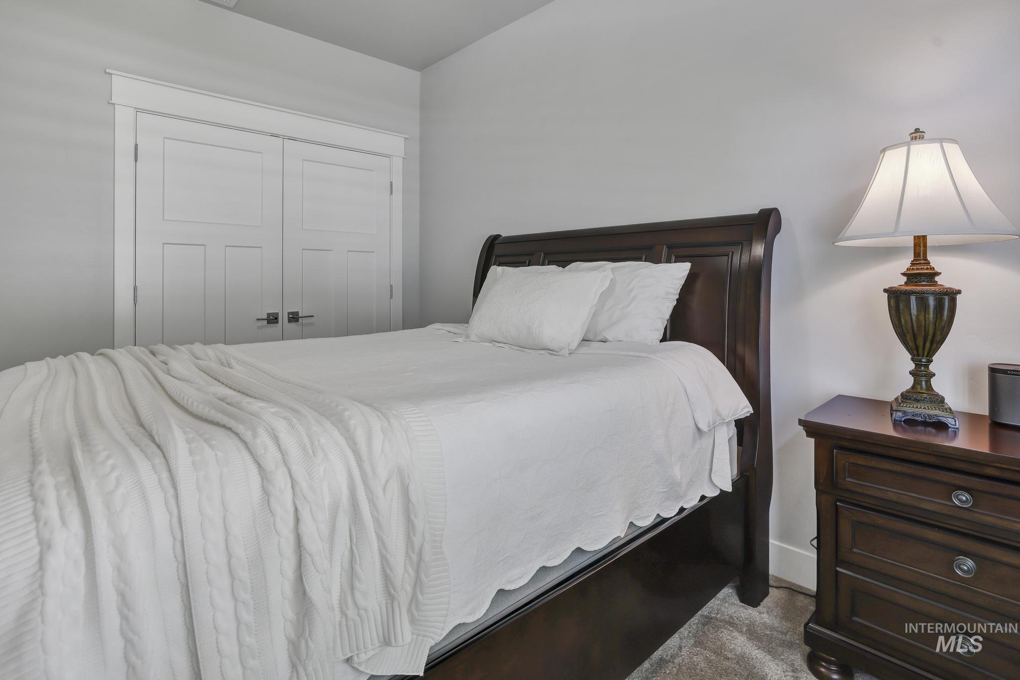 1937 Tamarack Loop Twin Falls, ID 83301 - Photo 25 of 50 Carpeted room featuring light gray walls, white trim, and a built-in closet with white paneled bifold doors and dark hardware