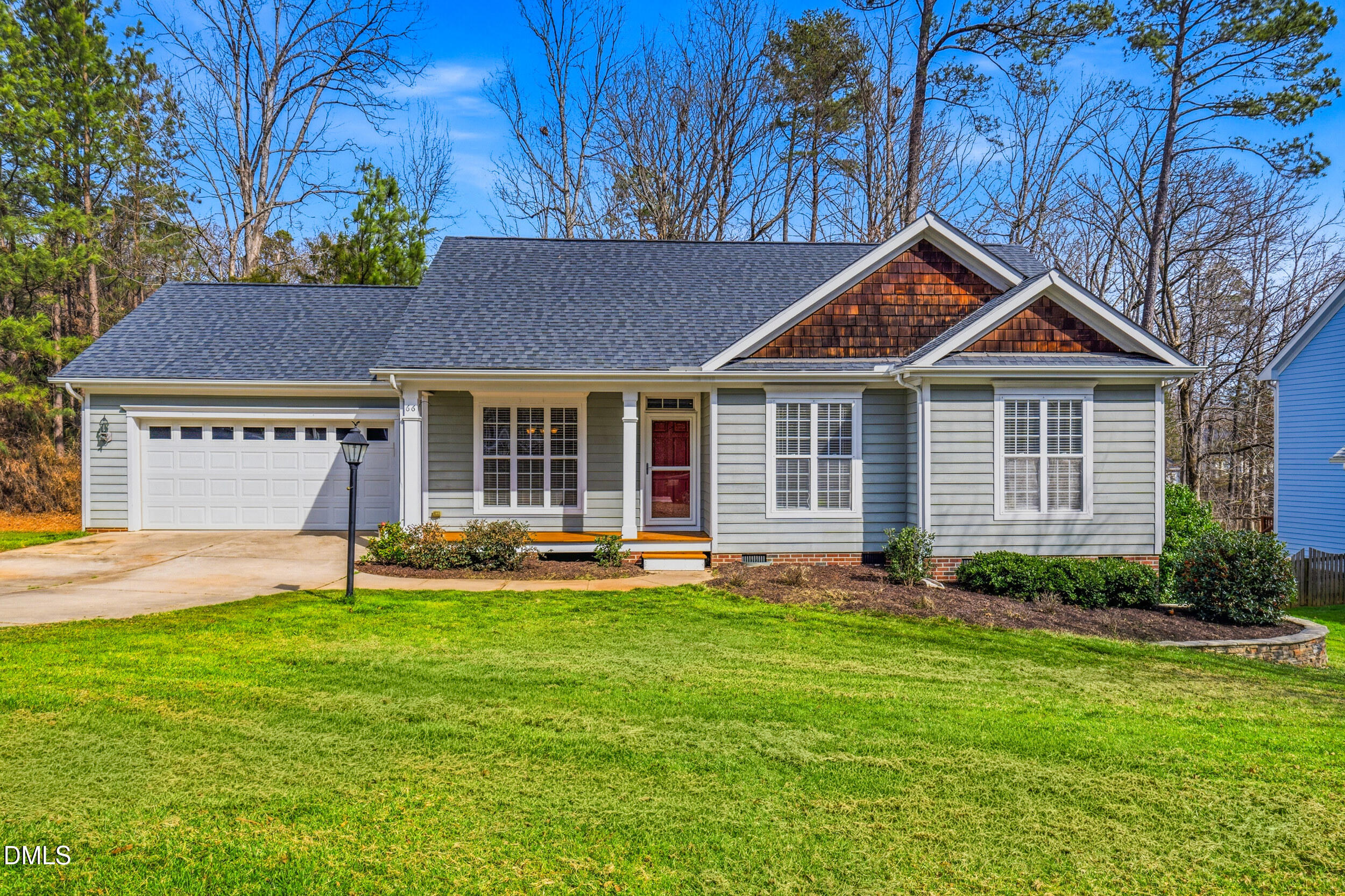 66 Bellemont Road Pittsboro, NC 27312 - Photo 1 of 33 a front view of a house with a garden and yard