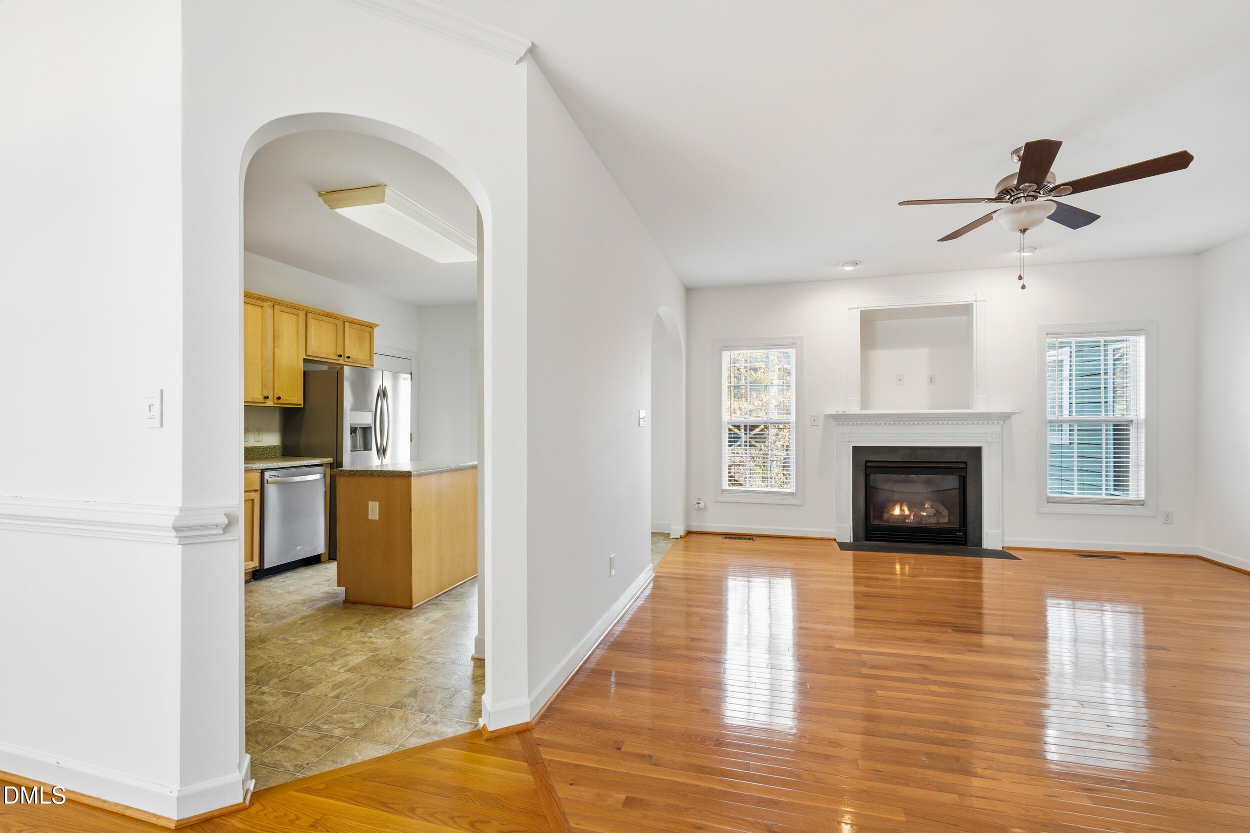 66 Bellemont Road Pittsboro, NC 27312 - Photo 20 of 33 a view of a livingroom with a fireplace a chandelier and wooden floor