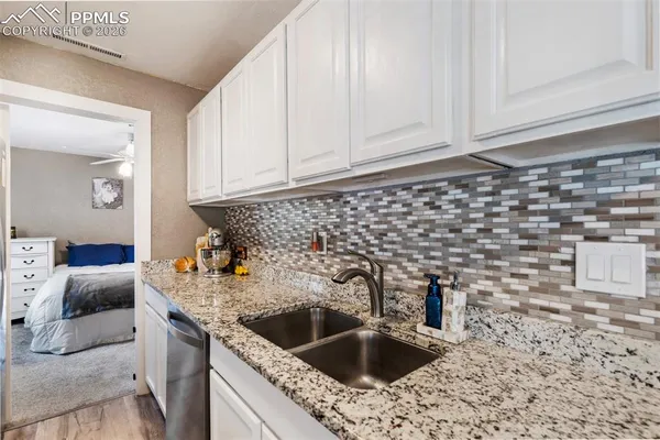 a kitchen with a sink and cabinets