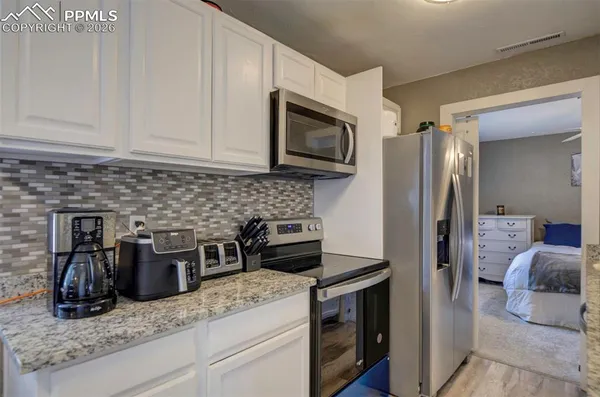 a kitchen with a stove microwave and refrigerator