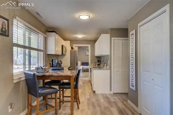 a view of a dining room with furniture and a window