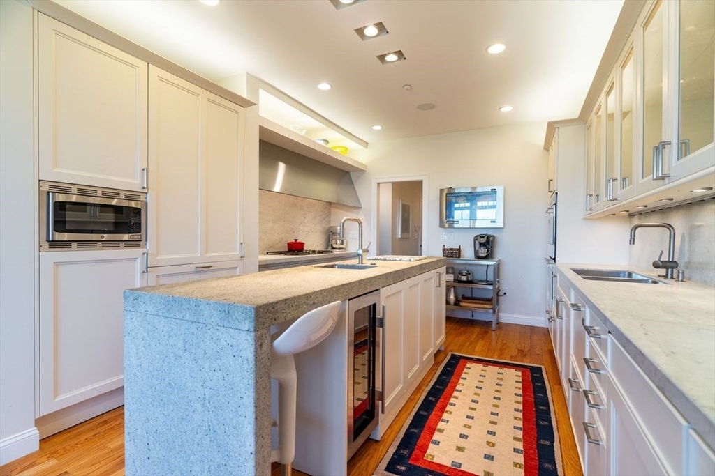 1 South Cottage Road, Unit 1 Belmont, MA 02478 - Photo 11 of 35 a kitchen with stainless steel appliances granite countertop a sink stove and refrigerator