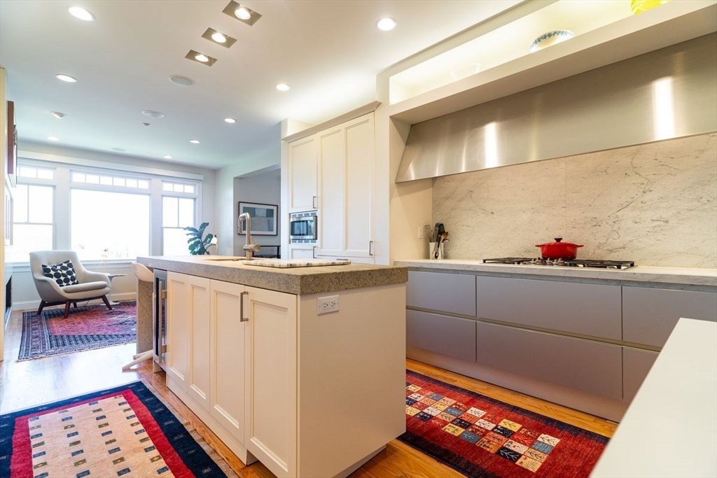 1 South Cottage Road, Unit 1 Belmont, MA 02478 - Photo 12 of 35 a kitchen with granite countertop sink stove and cabinets