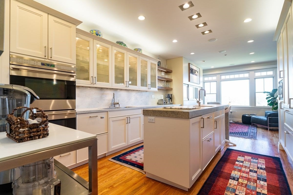 1 South Cottage Road, Unit 1 Belmont, MA 02478 - Photo 13 of 35 a kitchen with stainless steel appliances granite countertop a sink stove and cabinets
