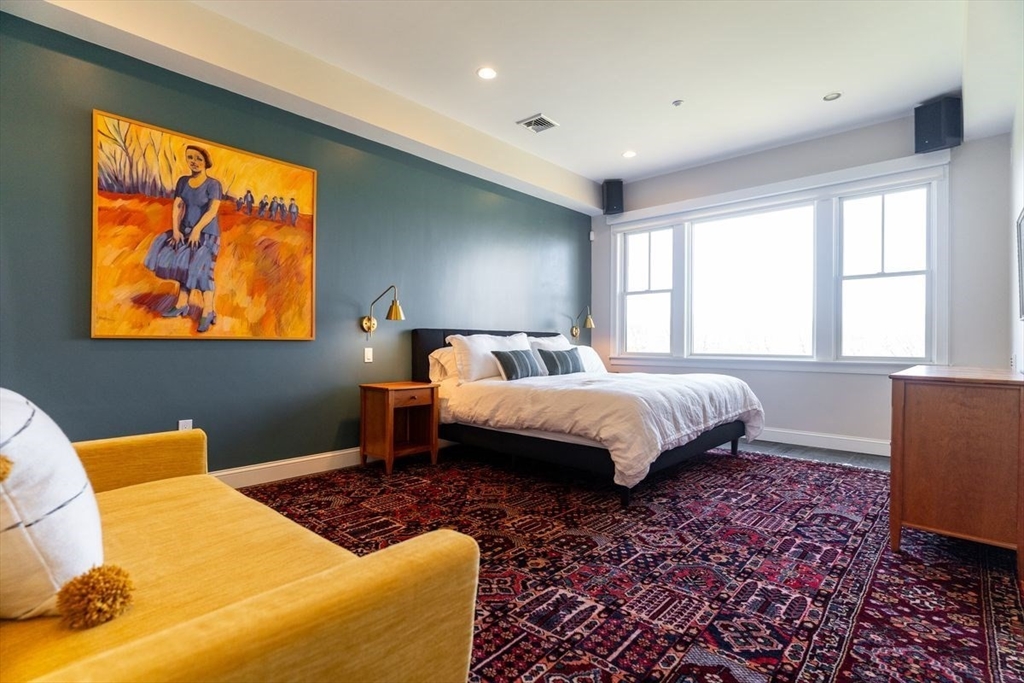 1 South Cottage Road, Unit 1 Belmont, MA 02478 - Photo 17 of 35 a bedroom with a bed and wooden floor