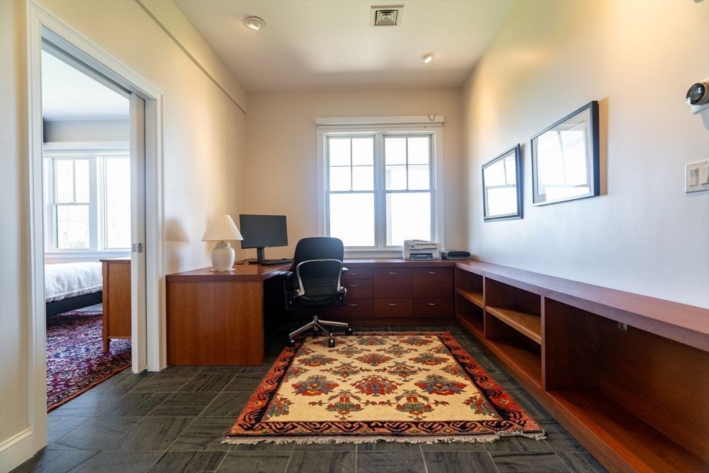 1 South Cottage Road, Unit 1 Belmont, MA 02478 - Photo 18 of 35 a bed sitting in a bedroom next to a window