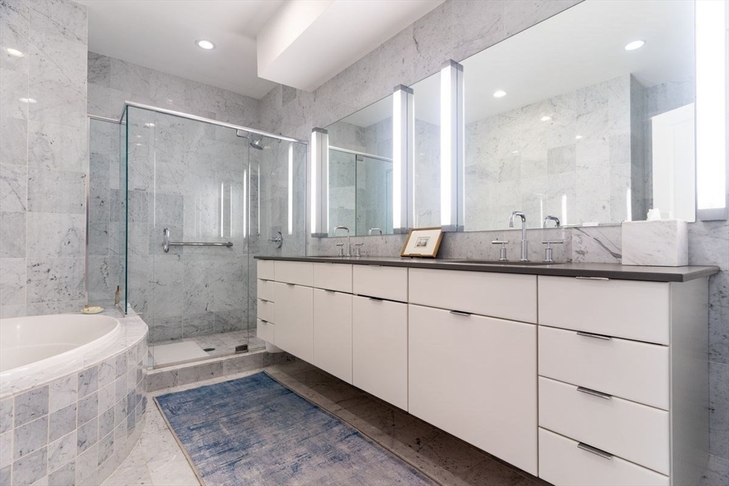 1 South Cottage Road, Unit 1 Belmont, MA 02478 - Photo 22 of 35 a bathroom with a granite countertop sink mirror and a bathtub