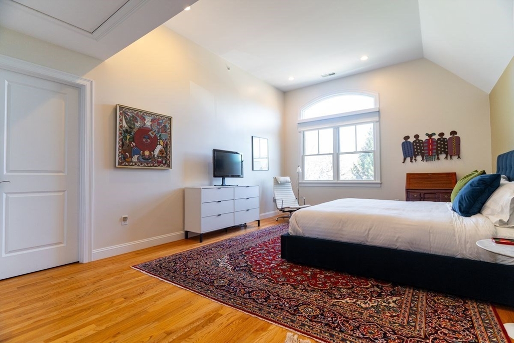 1 South Cottage Road, Unit 1 Belmont, MA 02478 - Photo 23 of 35 a bedroom with a large bed and a window