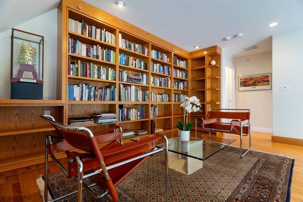 1 South Cottage Road, Unit 1 Belmont, MA 02478 - Photo 9 of 35 a reading room with furniture rug and a book shelf