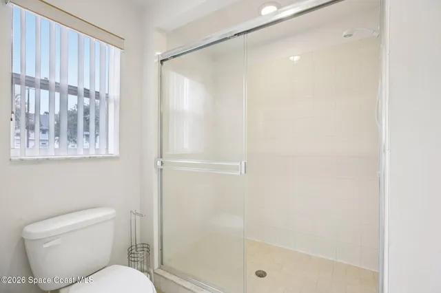 a white toilet sitting next to a bathroom sink
